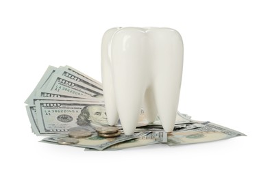 Ceramic model of tooth, dollar banknotes and coins on white background. Expensive treatment