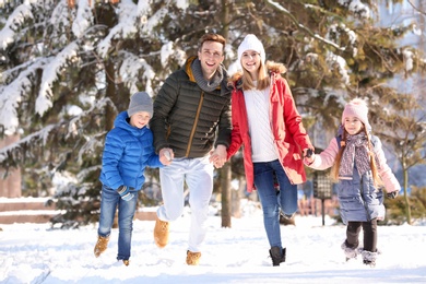 Happy family running in winter park