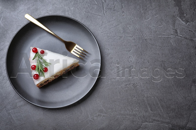 Photo of Slice of traditional Christmas cake served on black table, top view. Space for text