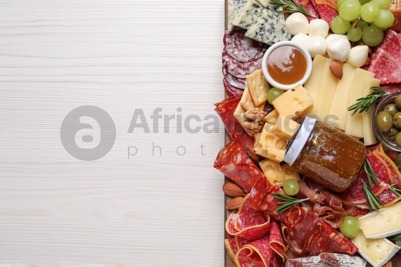 Assorted appetizer served on white wooden table, top view. Space for text