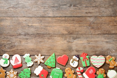 Photo of Tasty homemade Christmas cookies on wooden background, flat lay. Space for text