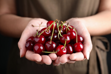 Woman holding sweet juicy cherries, closeup view