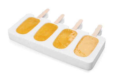 Tasty orange ice pops in mold isolated on white. Fruit popsicle