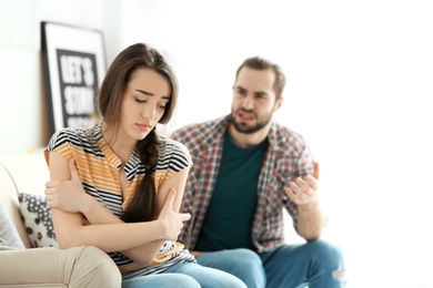 Young couple having argument in living room