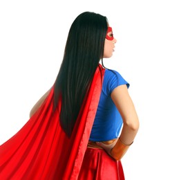 Confident young woman wearing superhero costume on white background