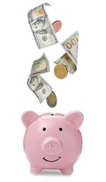 Banknotes and coins falling into piggy bank on white background. Saving money