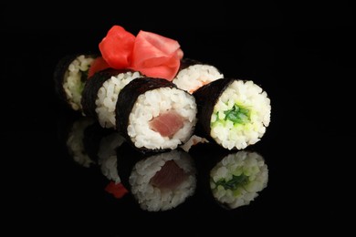 Photo of Set of delicious sushi rolls on black background, closeup