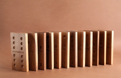 Wooden domino tiles with pips on brown background