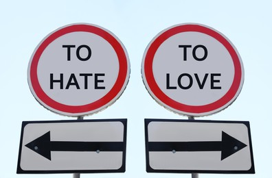 Road signs with different directions - TO HATE or TO LOVE outdoors