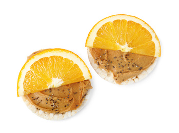 Puffed rice cakes with peanut butter and orange isolated on white, top view