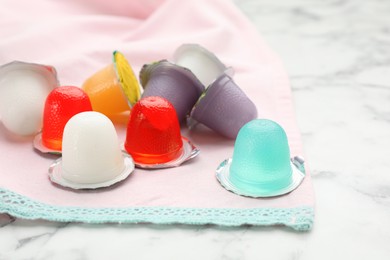 Tasty bright jelly cups on white marble table