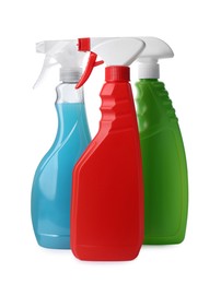 Spray bottles with detergents on white background. Cleaning supplies