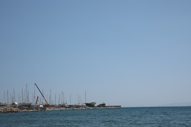 Picturesque view of pier with boats and calm sea on sunny day