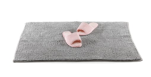 New grey bath mat with soft slippers isolated on white