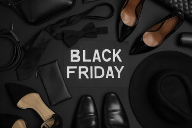 Flat lay composition with stylish accessories and phrase Black Friday on dark background