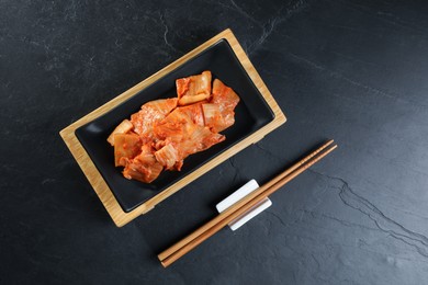 Delicious kimchi with Chinese cabbage served on grey table, flat lay