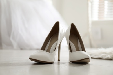 White wedding shoes on floor in room