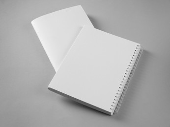 Blank brochure and notebook on grey background. Mockup for design