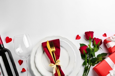 Beautiful table setting on white background, flat lay with space for text. Valentine's Day dinner