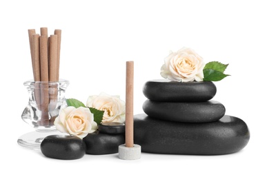 Aromatic incense sticks, roses and spa stones on white background