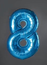 Photo of Blue number eight balloon on grey background