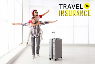 Travel insurance concept. Young couple with suitcase in airport