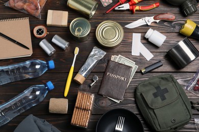 Disaster supply kit for earthquake on wooden table, flat lay