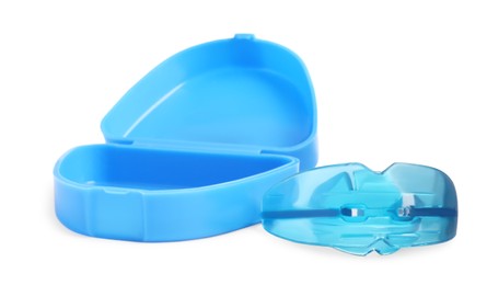 Photo of Transparent dental mouth guard and container on white background. Bite correction