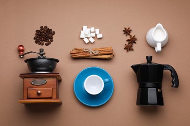 Photo of Flat lay composition with vintage manual grinder and geyser coffee maker on brown background