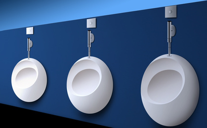 Clean ceramic urinals in men's public bathroom