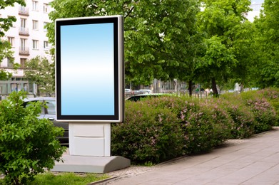 Blank advertising board on city street. Mockup for design