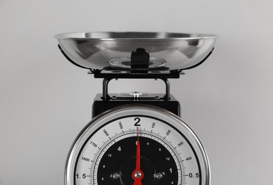 Retro mechanical kitchen scale on light grey background, closeup