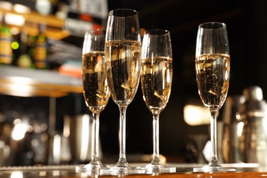 Glasses of champagne on counter in bar