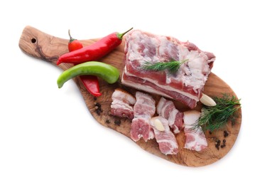 Photo of Pieces of pork fatback with chilli pepper and dill on white background, top view