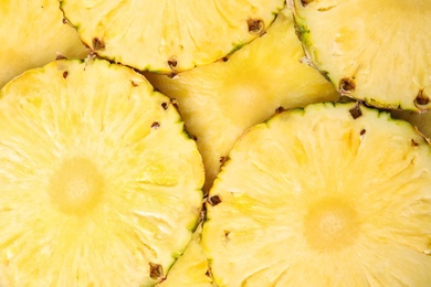 Photo of Slices of tasty ripe pineapple as background, top view
