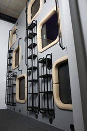 Photo of Capsules in modern pod hostel, low angle view. Stylish interior