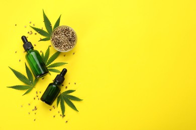 CBD oil, THC tincture, hemp leaves and grains on yellow background, flat lay. Space for text