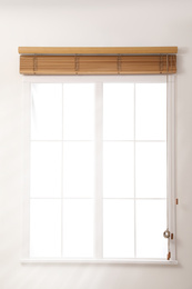 Modern window with open wooden blinds indoors