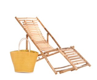 Photo of Wooden sun lounger and female bag on white background. Beach accessories