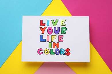 Words Live Your Life In Colors on bright colorful background, top view