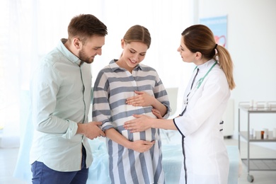 Gynecology consultation. Future parents with doctor in hospital