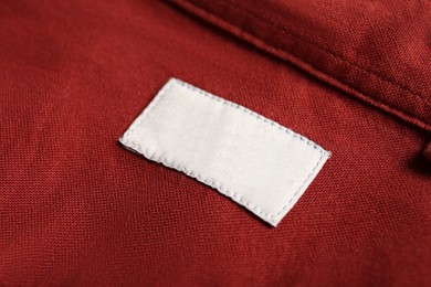 Blank clothing label on red shirt, closeup