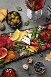 Set of different delicious appetizers served on grey table, flat lay