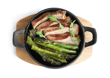 Tasty meat with asparagus and sprouts in portioned frying pan isolated on white, top view