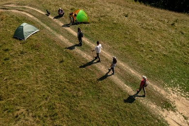Group of tourists near tents in campsite, aerial view. Drone photography