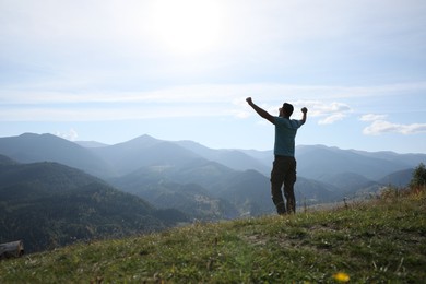 Photo of Happy tourist in mountains on sunny day