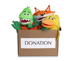 Donation box full of different toys isolated on white