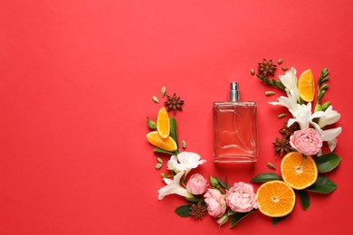 Flat lay composition with bottle of perfume and fresh citrus fruits on red background. Space for text