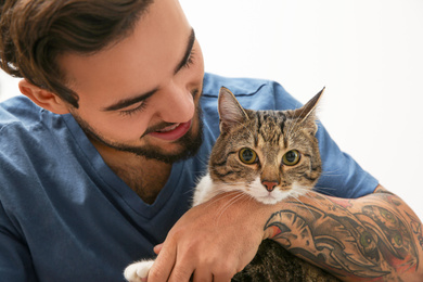 Happy man with cat at home. Friendly pet
