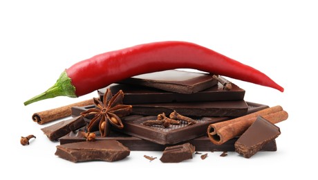 Photo of Red hot chili pepper and pieces of dark chocolate with spices isolated on white